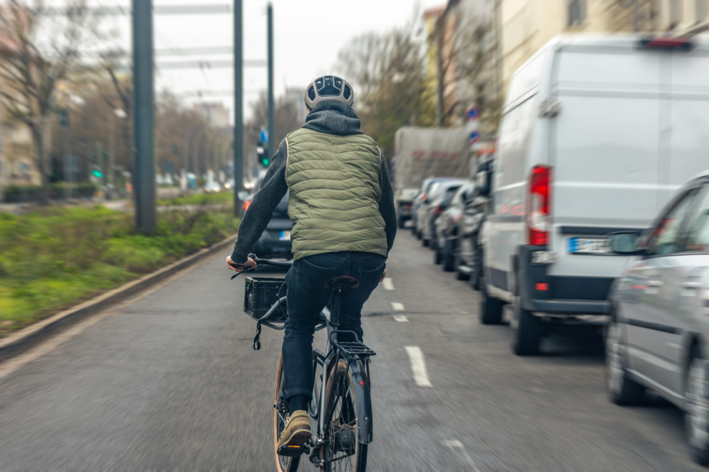 cyclist riding city traffic klein