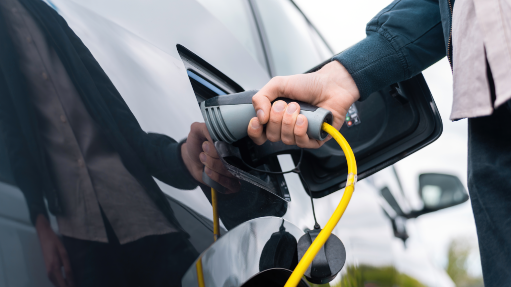 man plugging charger klein